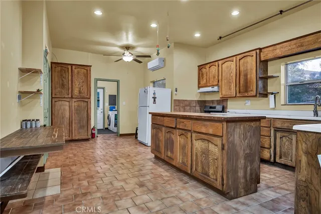 a kitchen with stainless steel appliances granite countertop a stove sink and cabinets