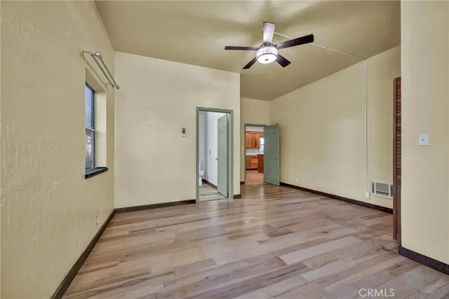 a bathroom with a granite countertop toilet and a sink