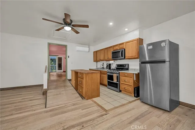 a view of a livingroom with wooden floor and staircase