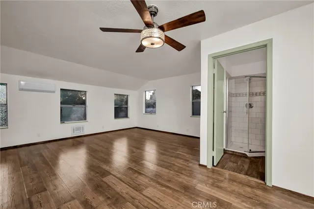 an aerial view of residential houses with outdoor space and trees all around