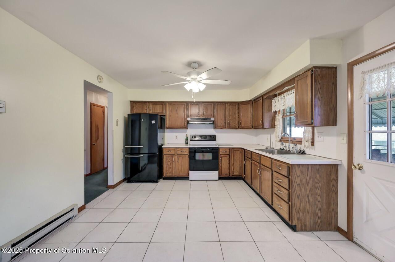 309 Lowery Street Scranton, PA 18505 - Photo 25 of 65 a large kitchen with stainless steel appliances kitchen island granite countertop a refrigerator and a sink