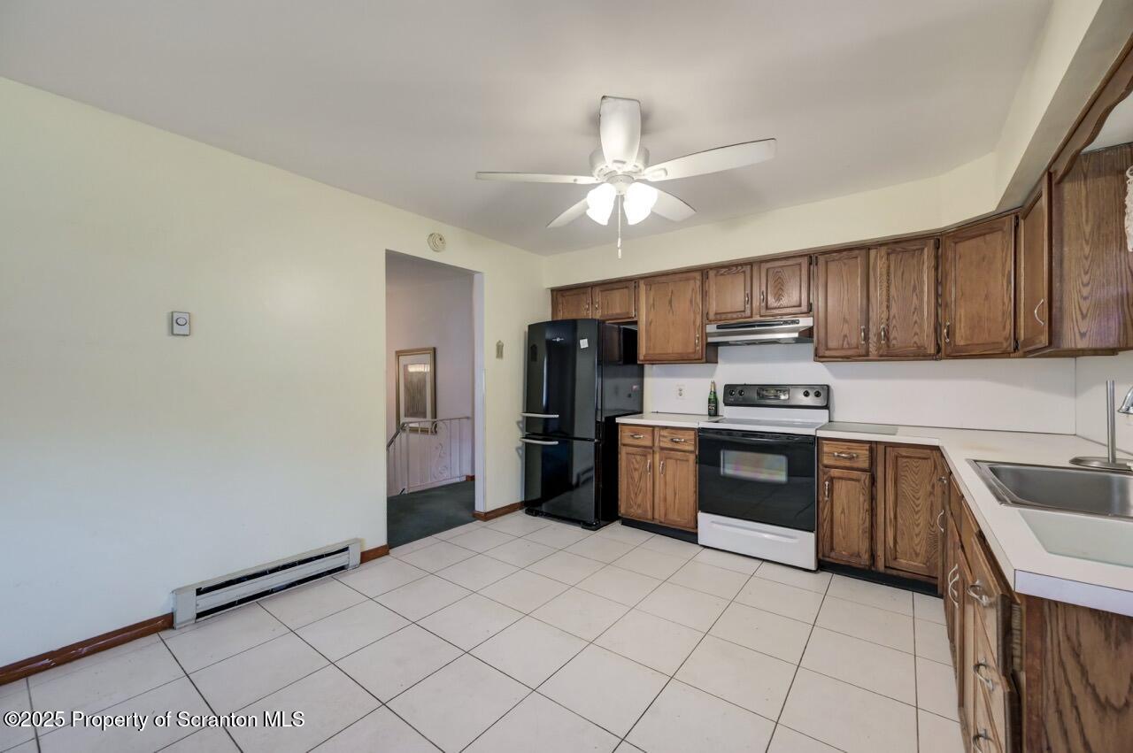 309 Lowery Street Scranton, PA 18505 - Photo 26 of 65 a kitchen with stainless steel appliances granite countertop a refrigerator and a stove top oven