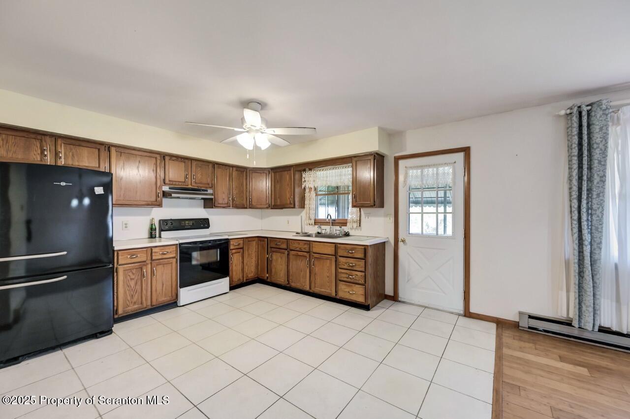 309 Lowery Street Scranton, PA 18505 - Photo 27 of 65 a large kitchen with a stove a refrigerator and a sink
