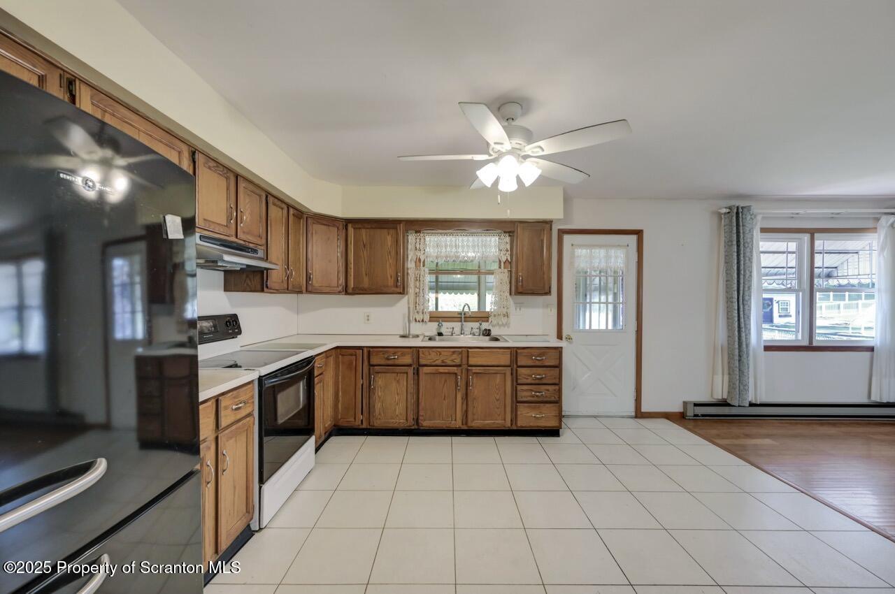 309 Lowery Street Scranton, PA 18505 - Photo 28 of 65 a kitchen with stainless steel appliances granite countertop a stove a sink and a refrigerator