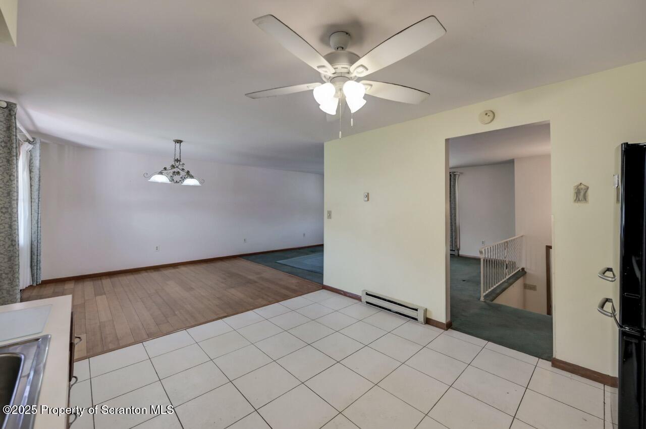 309 Lowery Street Scranton, PA 18505 - Photo 29 of 65 a view of a livingroom with a chandelier fan and kitchen area