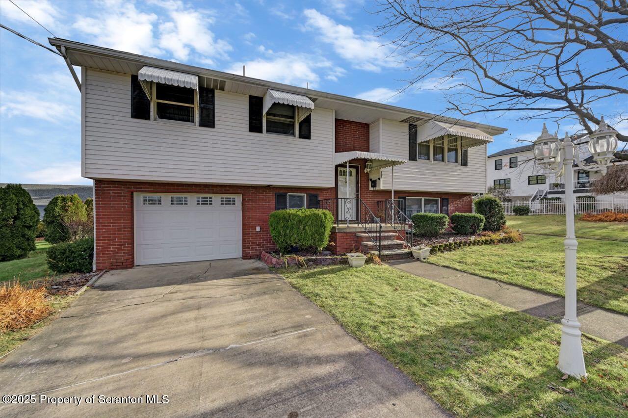 309 Lowery Street Scranton, PA 18505 - Photo 3 of 65 a front view of a house with garden