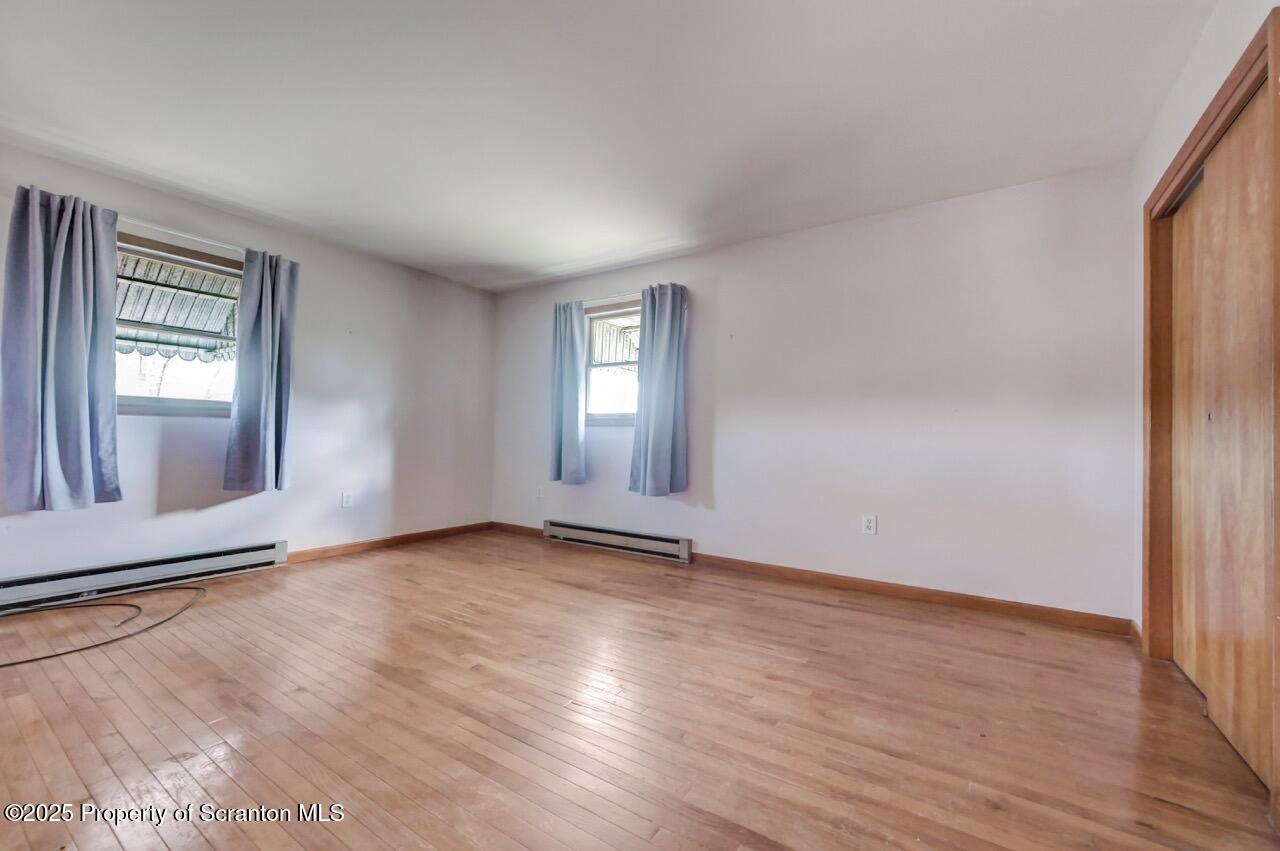 309 Lowery Street Scranton, PA 18505 - Photo 31 of 65 an empty room with wooden floor and windows