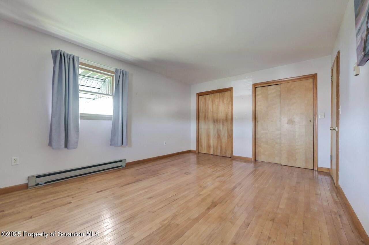 309 Lowery Street Scranton, PA 18505 - Photo 32 of 65 an empty room with wooden floor and window