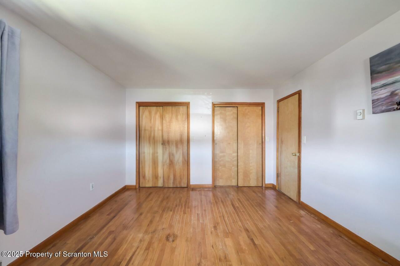 309 Lowery Street Scranton, PA 18505 - Photo 33 of 65 an empty room with wooden floor and windows
