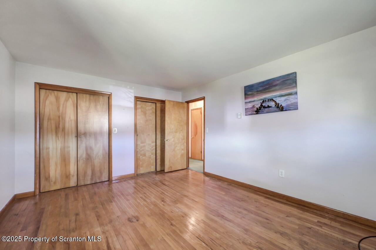 309 Lowery Street Scranton, PA 18505 - Photo 34 of 65 an empty room with wooden floor and windows