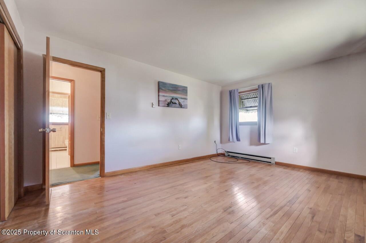 309 Lowery Street Scranton, PA 18505 - Photo 35 of 65 an empty room with wooden floor and windows