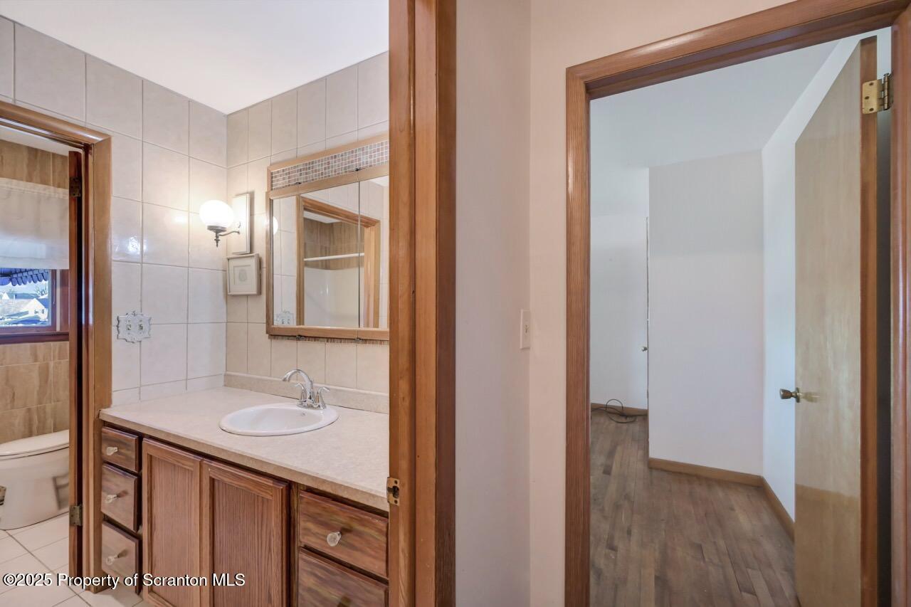 309 Lowery Street Scranton, PA 18505 - Photo 36 of 65 a bathroom with a sink a mirror and a shower