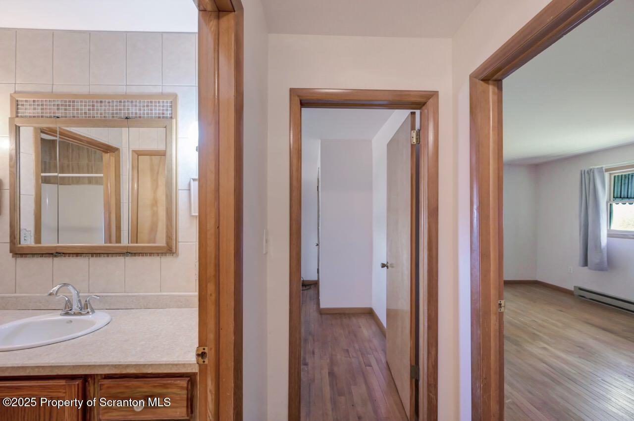 309 Lowery Street Scranton, PA 18505 - Photo 37 of 65 a view of a bathroom from a hallway