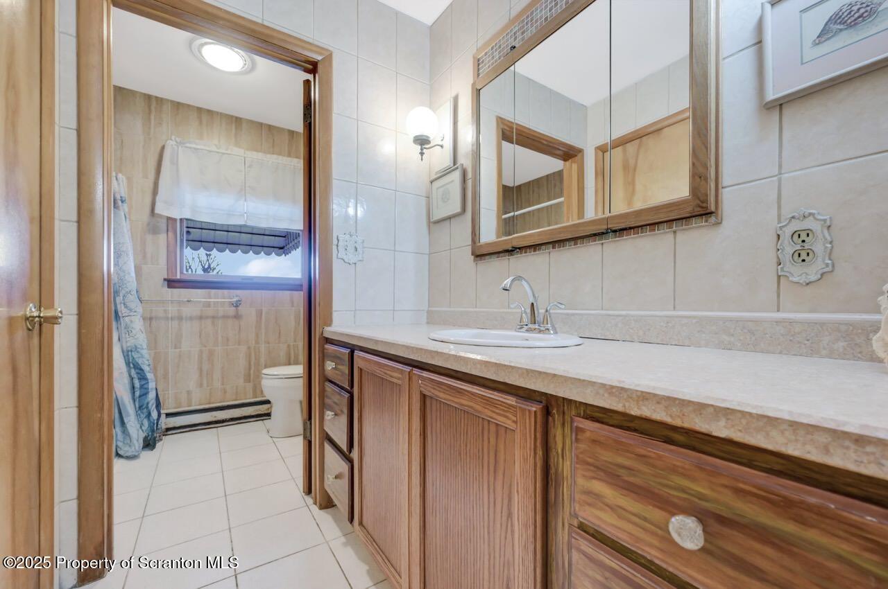 309 Lowery Street Scranton, PA 18505 - Photo 38 of 65 a bathroom with a sink and a mirror