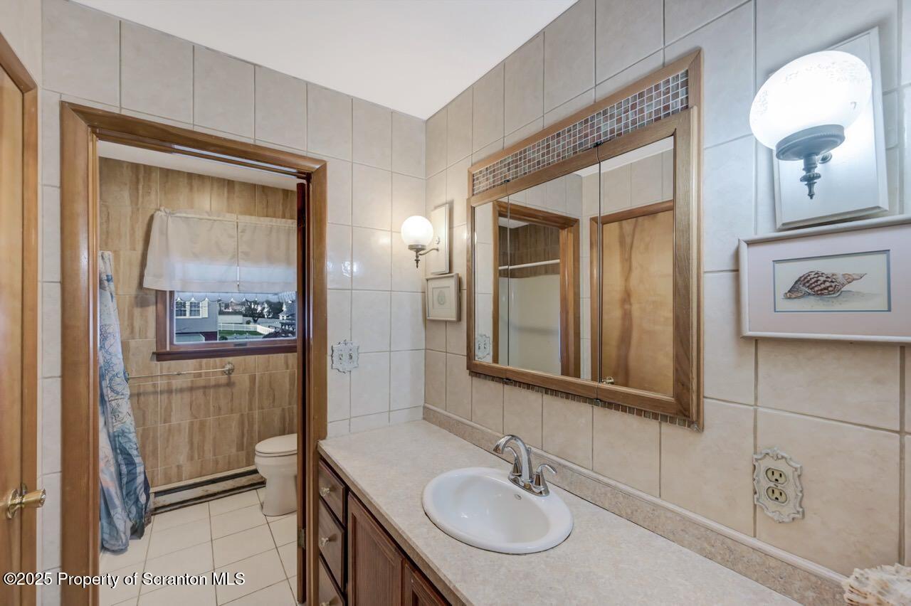 309 Lowery Street Scranton, PA 18505 - Photo 39 of 65 a bathroom with a sink and a mirror