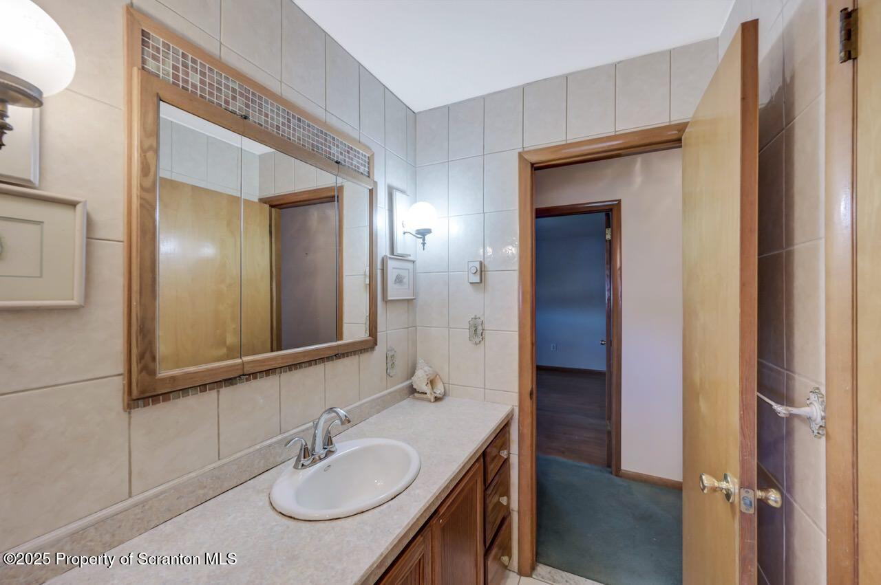 309 Lowery Street Scranton, PA 18505 - Photo 41 of 65 a bathroom with a sink and a mirror