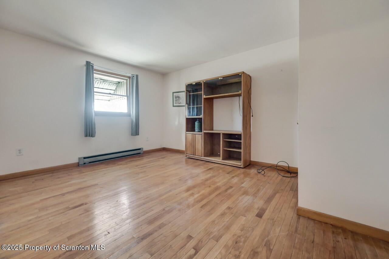 309 Lowery Street Scranton, PA 18505 - Photo 42 of 65 an empty room with wooden floor closet and windows