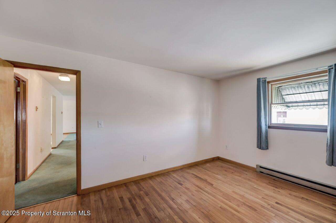 309 Lowery Street Scranton, PA 18505 - Photo 45 of 65 an empty room with wooden floor and windows