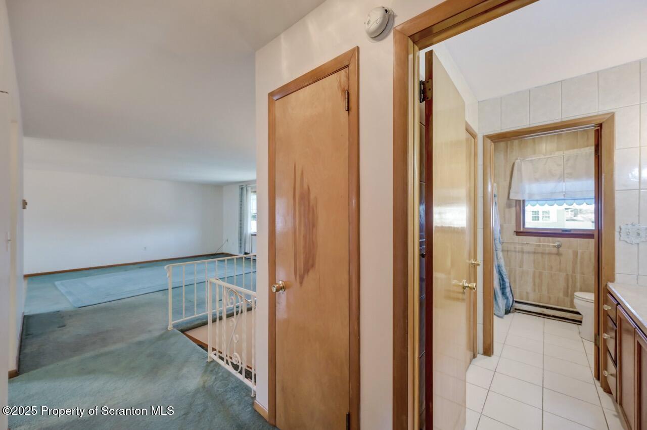309 Lowery Street Scranton, PA 18505 - Photo 46 of 65 a view of a hallway with wooden floor and staircase