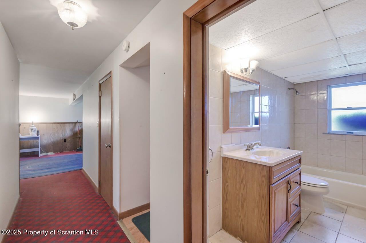 309 Lowery Street Scranton, PA 18505 - Photo 54 of 65 a bathroom with a sink a toilet and mirror