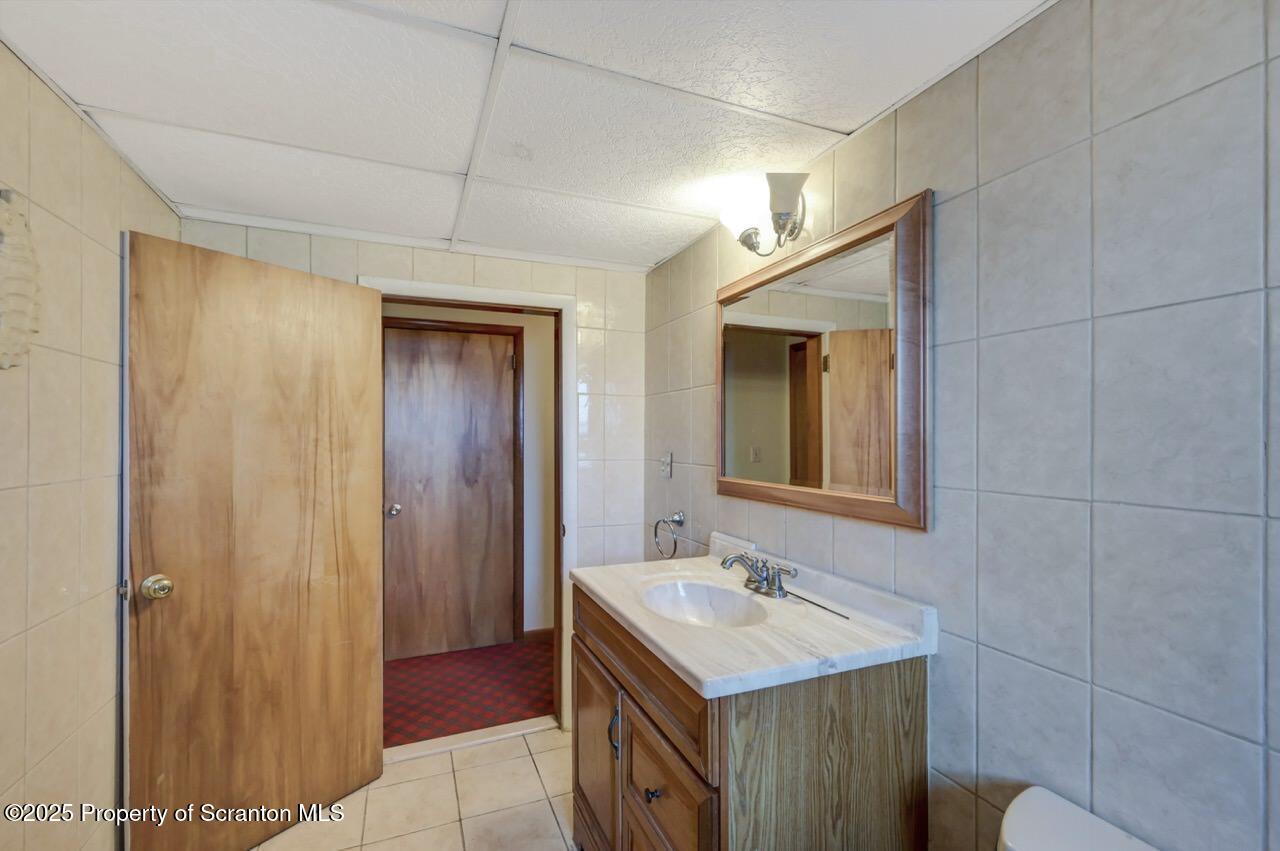 309 Lowery Street Scranton, PA 18505 - Photo 56 of 65 a bathroom with a sink a vanity and a mirror