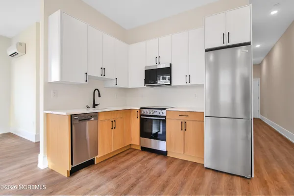 a kitchen with stainless steel appliances a refrigerator sink and microwave