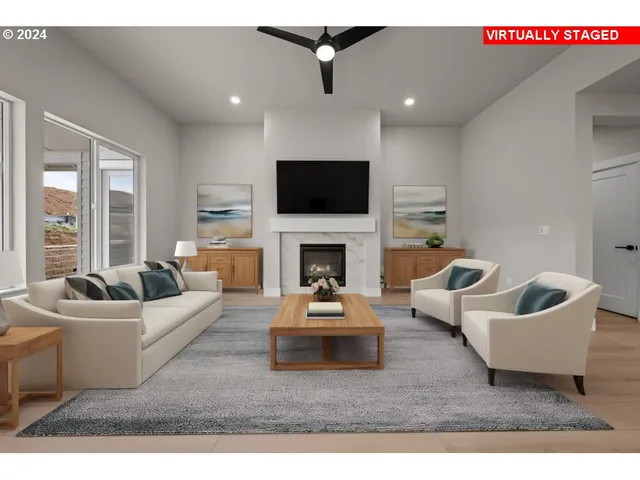 a living room with furniture a fireplace and a flat screen tv