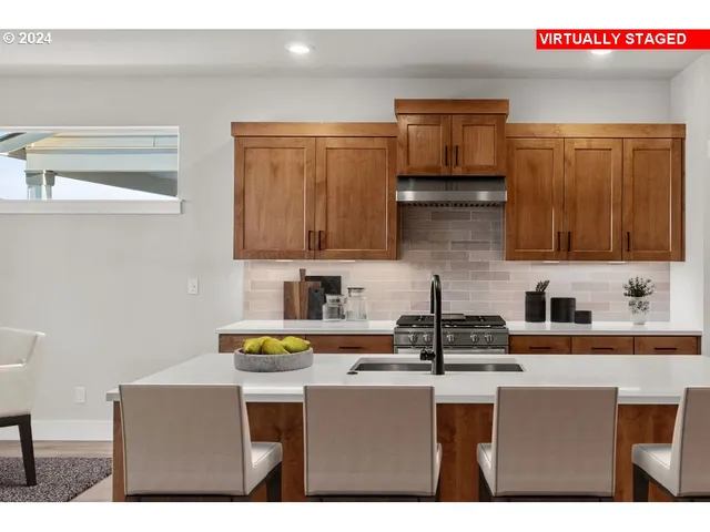 a kitchen with stainless steel appliances a sink cabinets and wooden floor
