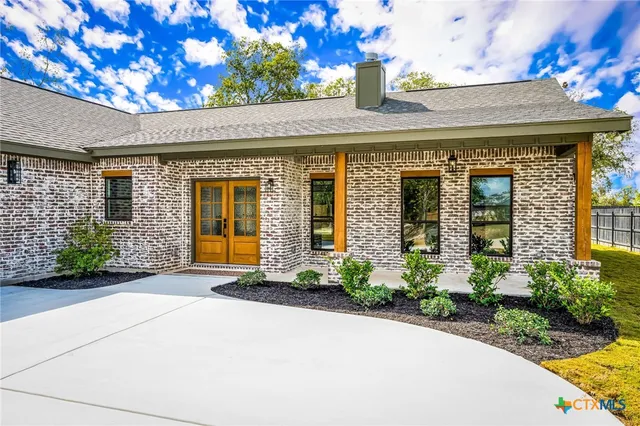 a front view of a house with garden