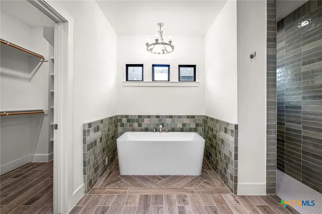 a spacious bathroom with a granite countertop sink mirror and shower