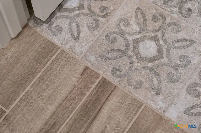 a bathroom with a bathtub shower sink vanity mirror and toilet