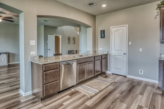 a spacious bathroom with a granite countertop sink and a mirror