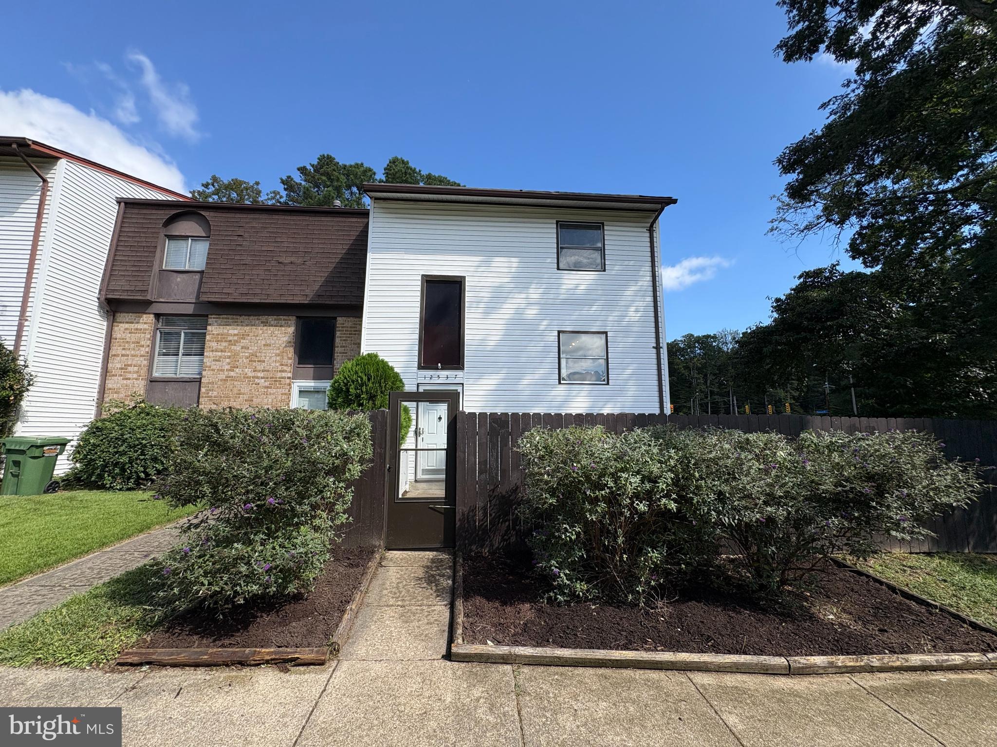 12537 Basque Place Woodbridge, VA 22192 - Photo 1 of 38 a front view of a house with garden