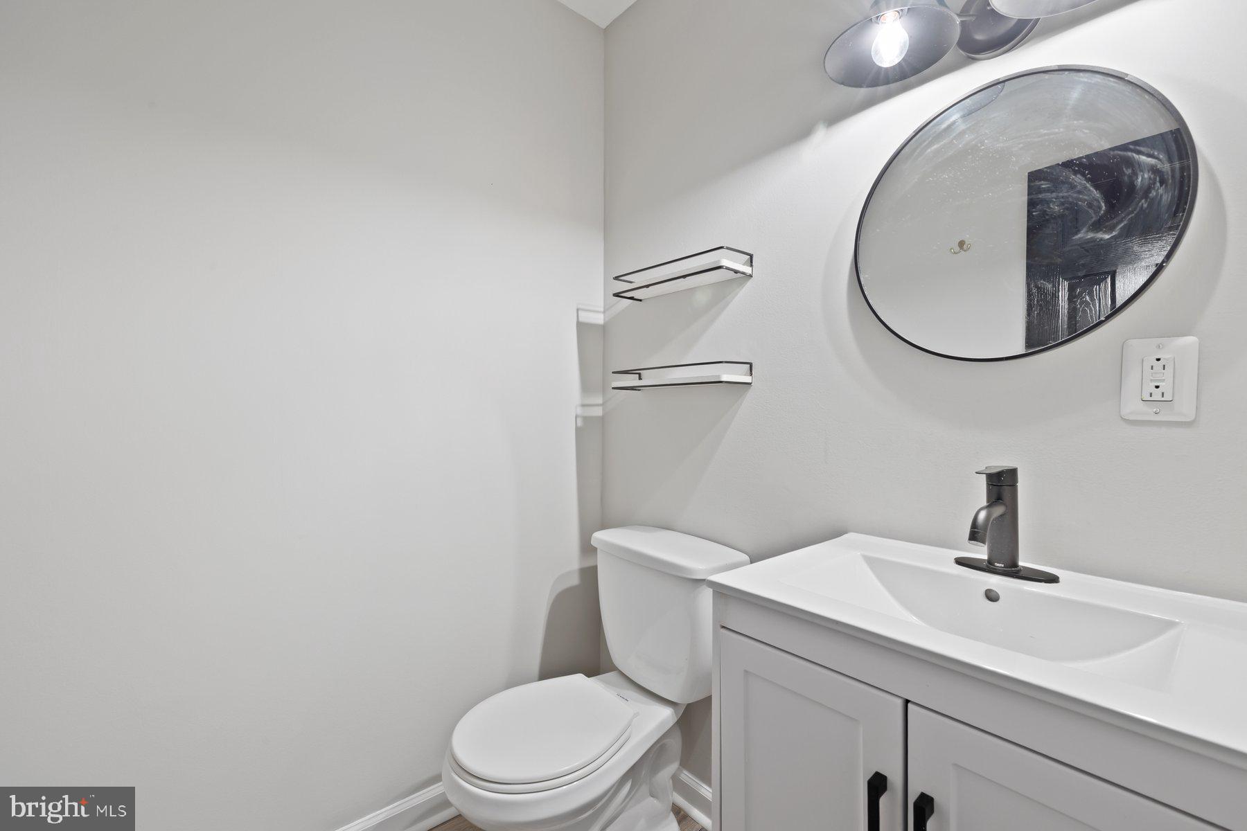 12537 Basque Place Woodbridge, VA 22192 - Photo 15 of 38 a bathroom with a toilet a sink and a mirror