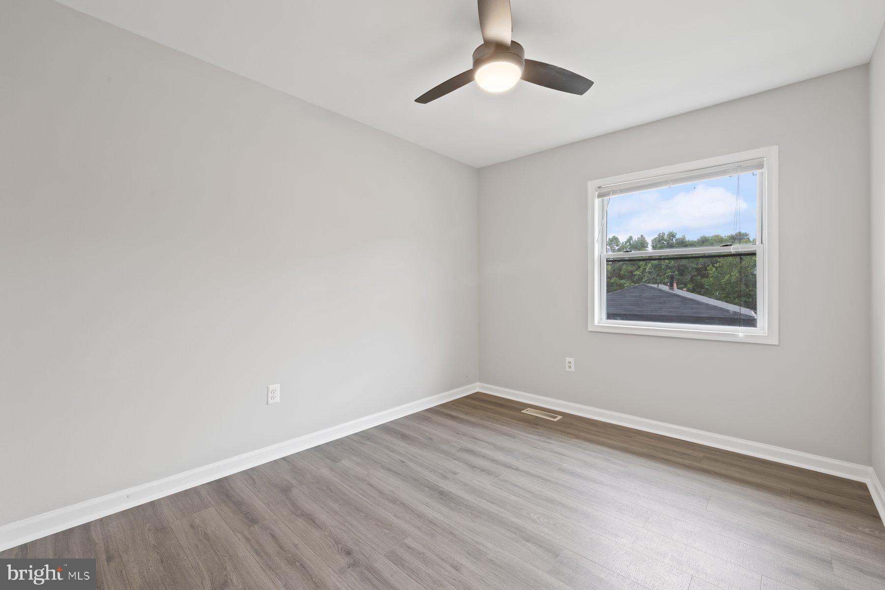 12537 Basque Place Woodbridge, VA 22192 - Photo 19 of 38 wooden floor in an empty room with a window