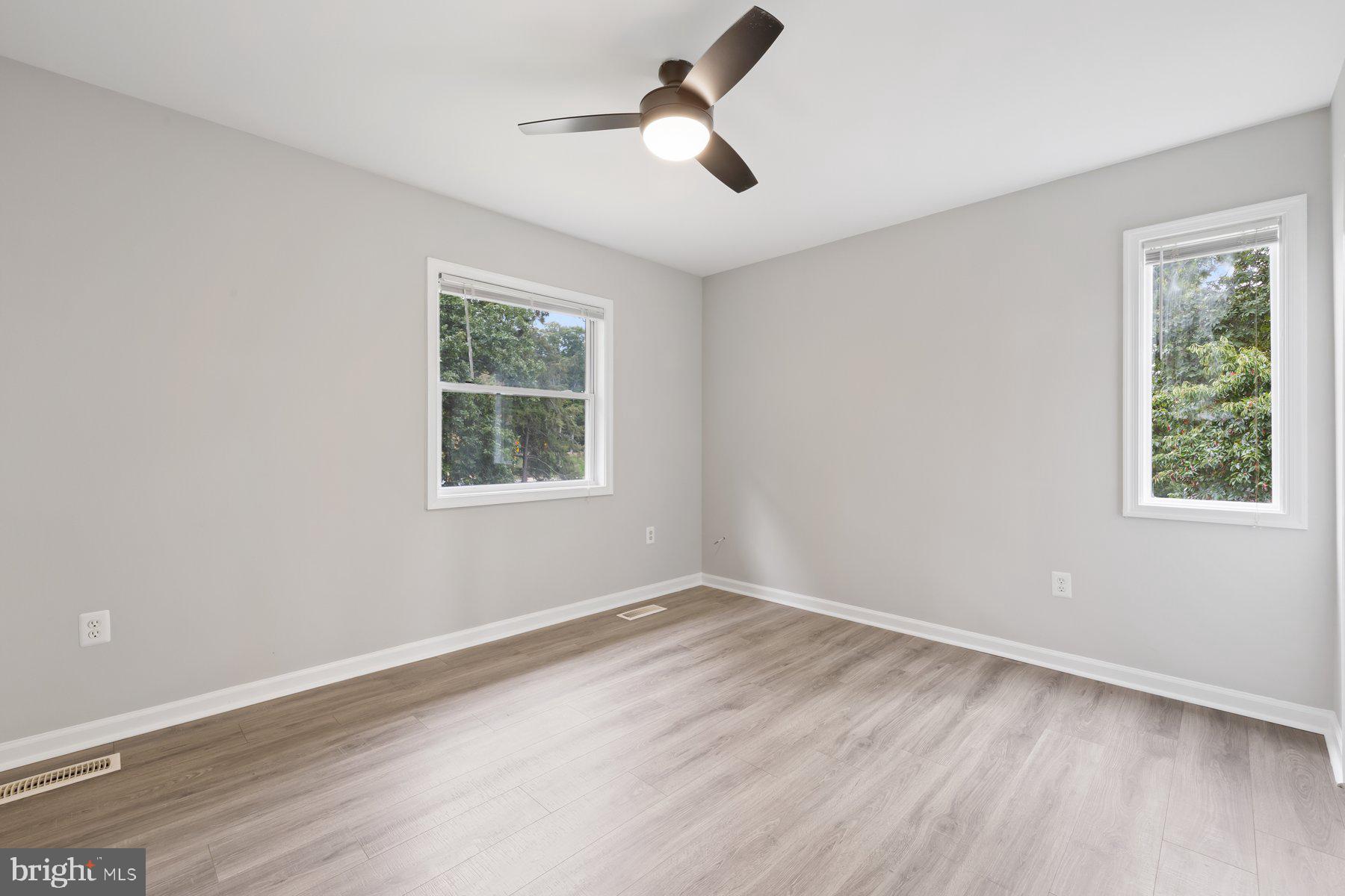 12537 Basque Place Woodbridge, VA 22192 - Photo 22 of 38 a view of empty room with wooden floor and fan