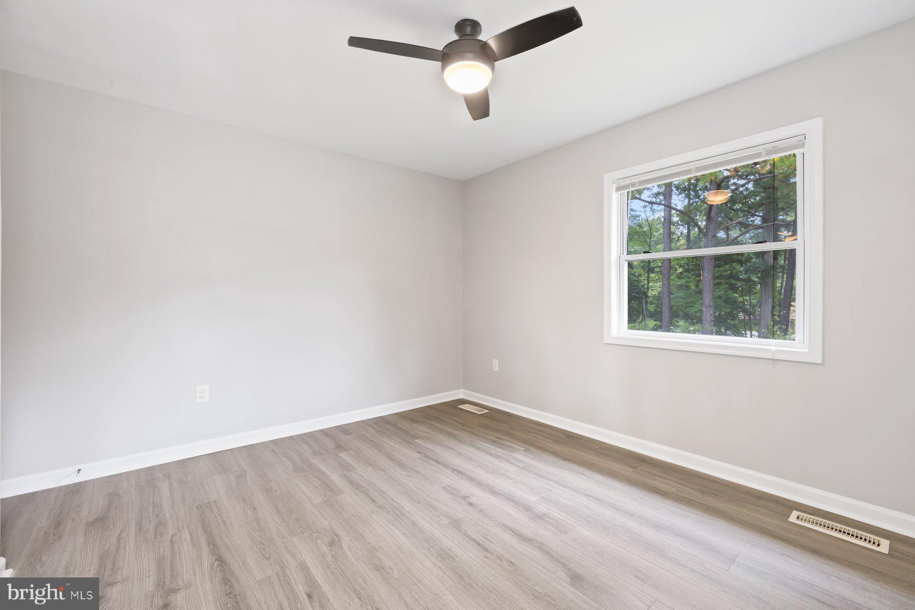 12537 Basque Place Woodbridge, VA 22192 - Photo 23 of 38 an empty room with a window and ceiling fan