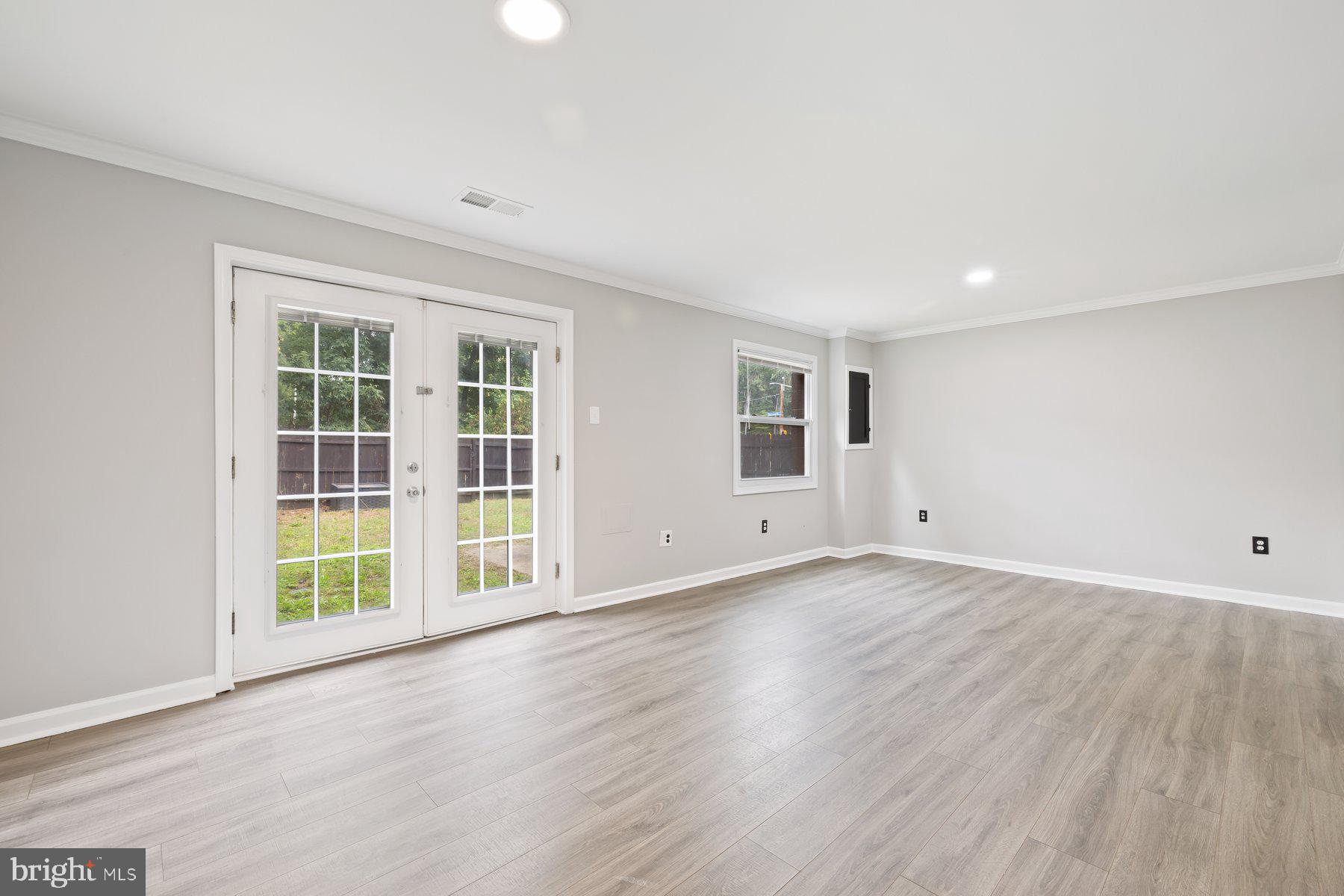 12537 Basque Place Woodbridge, VA 22192 - Photo 24 of 38 an empty room with wooden floor and windows
