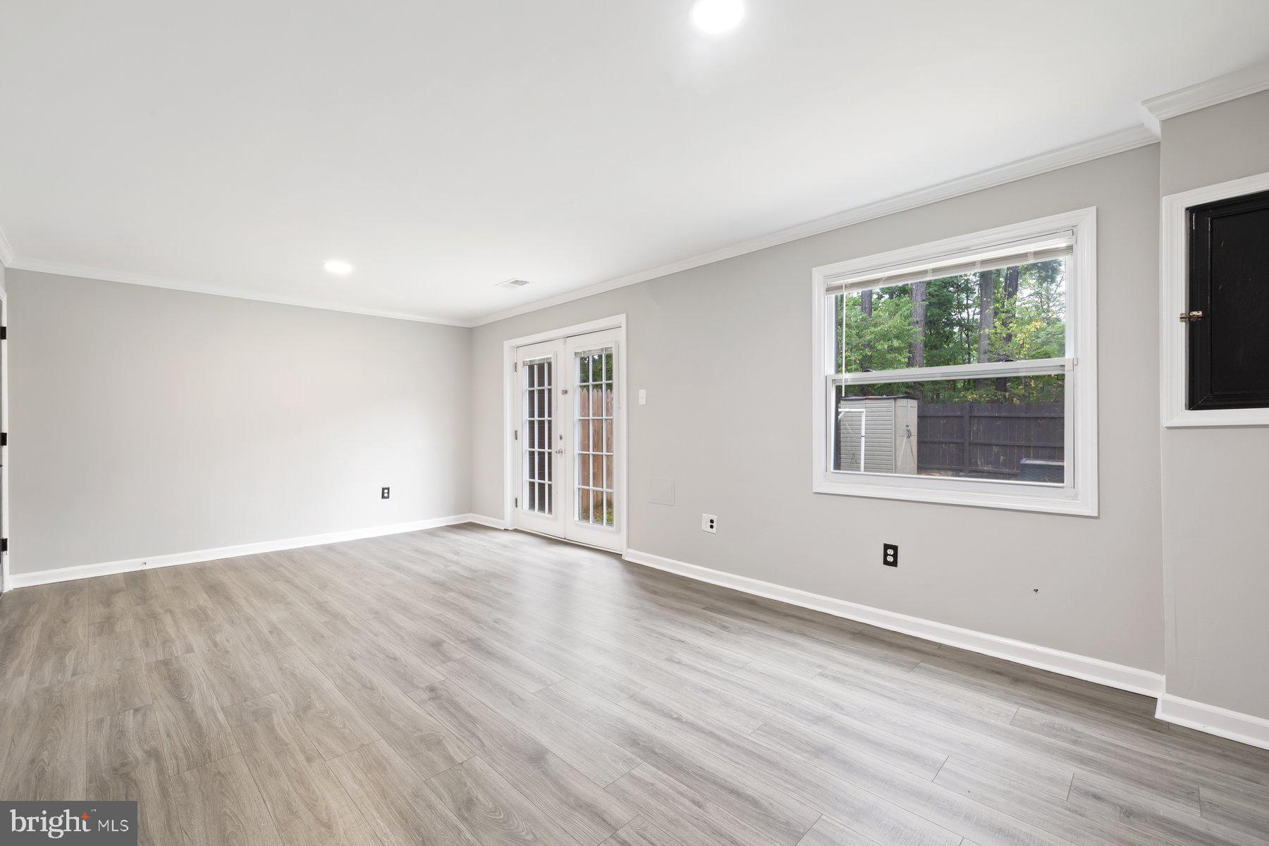 12537 Basque Place Woodbridge, VA 22192 - Photo 25 of 38 an empty room with wooden floor and windows