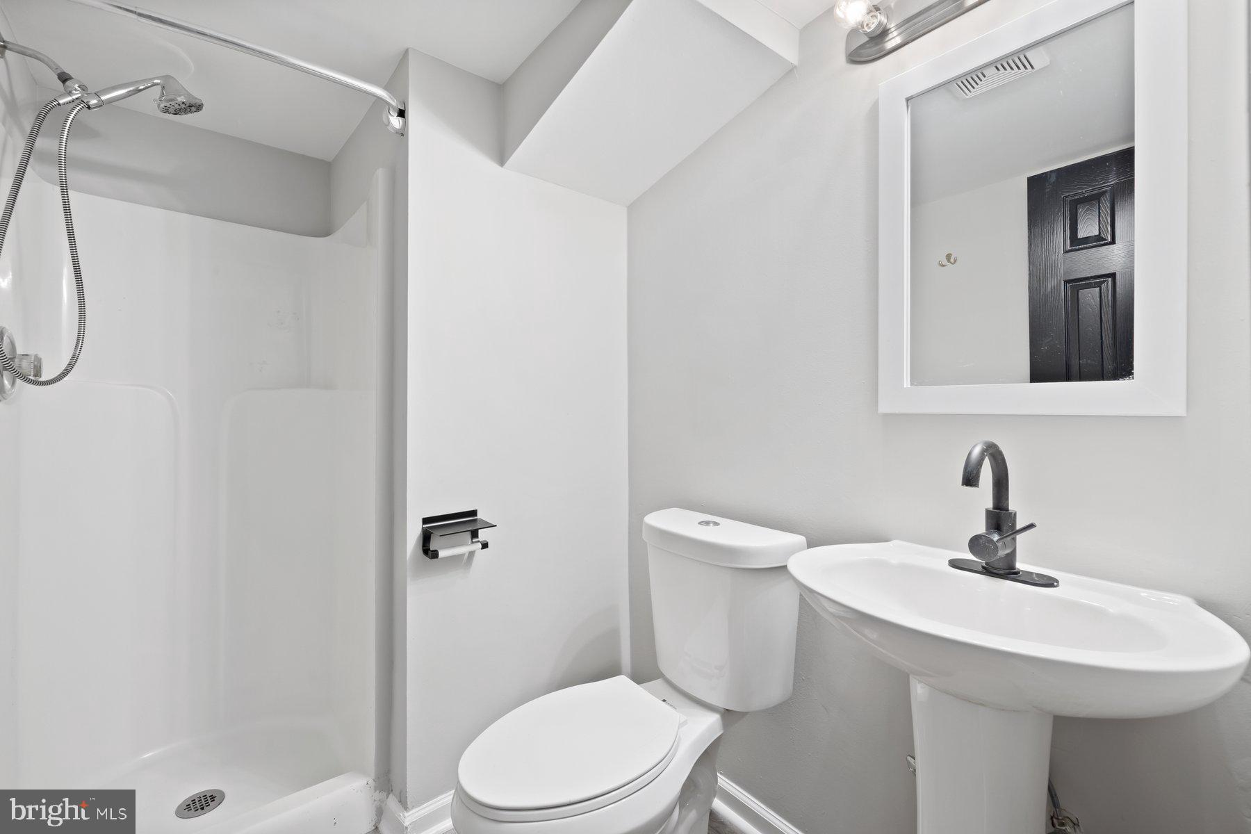 12537 Basque Place Woodbridge, VA 22192 - Photo 27 of 38 a bathroom with a toilet sink shower and mirror