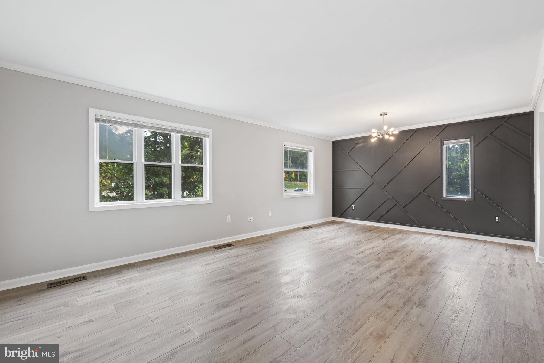 12537 Basque Place Woodbridge, VA 22192 - Photo 6 of 38 a view of an empty room with a window and wooden floor