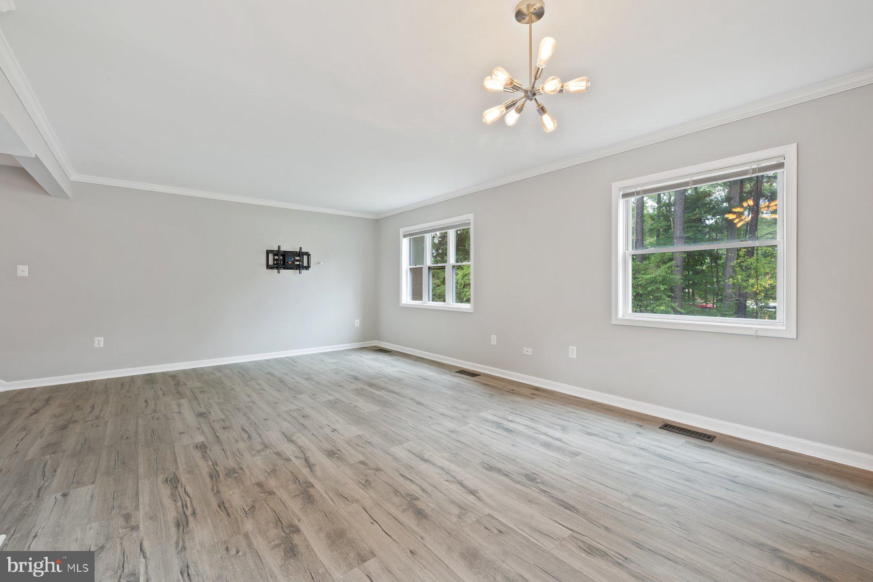12537 Basque Place Woodbridge, VA 22192 - Photo 7 of 38 a view of an empty room with wooden floor and a window