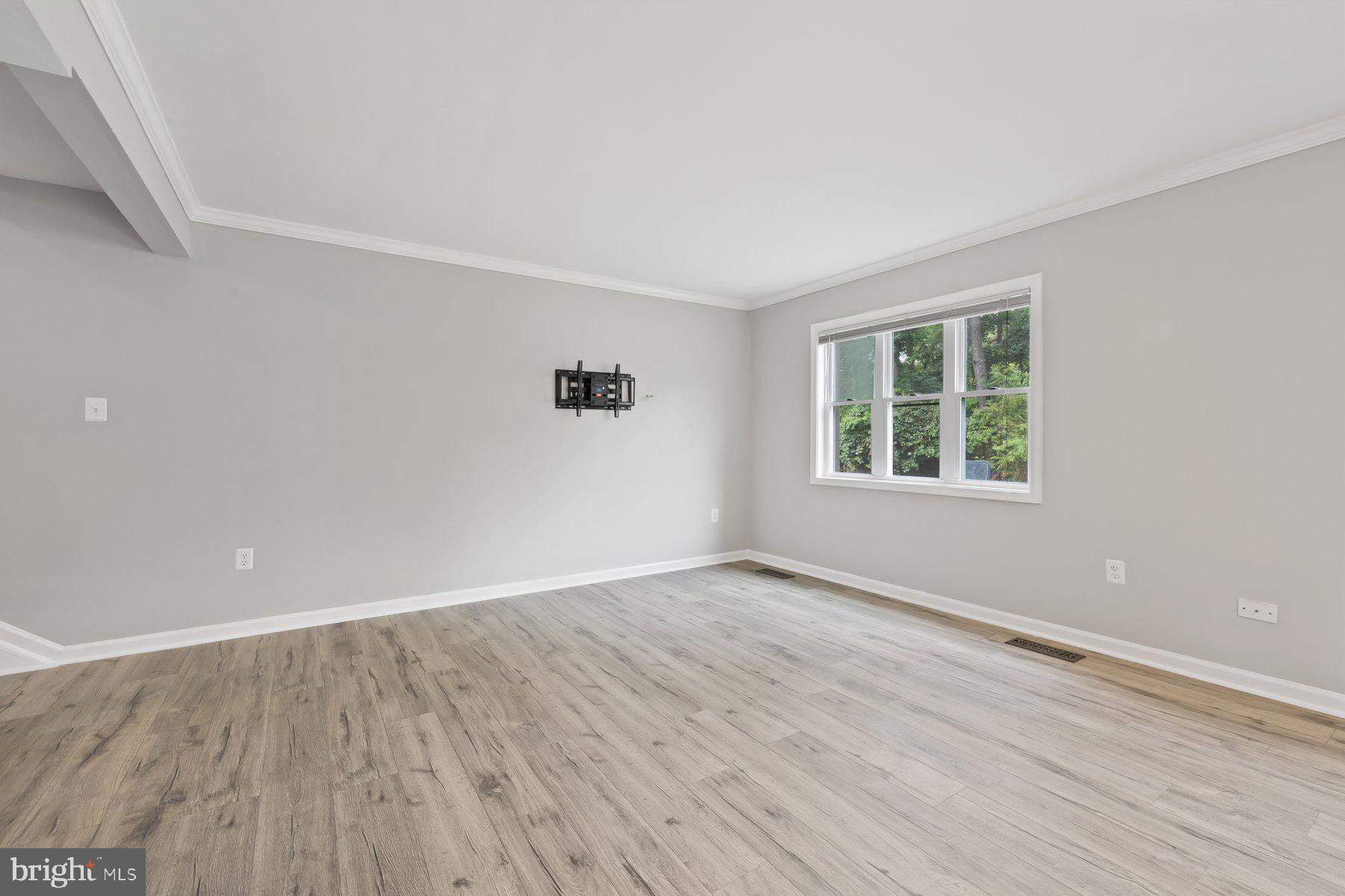 12537 Basque Place Woodbridge, VA 22192 - Photo 8 of 38 an empty room with wooden floor and windows