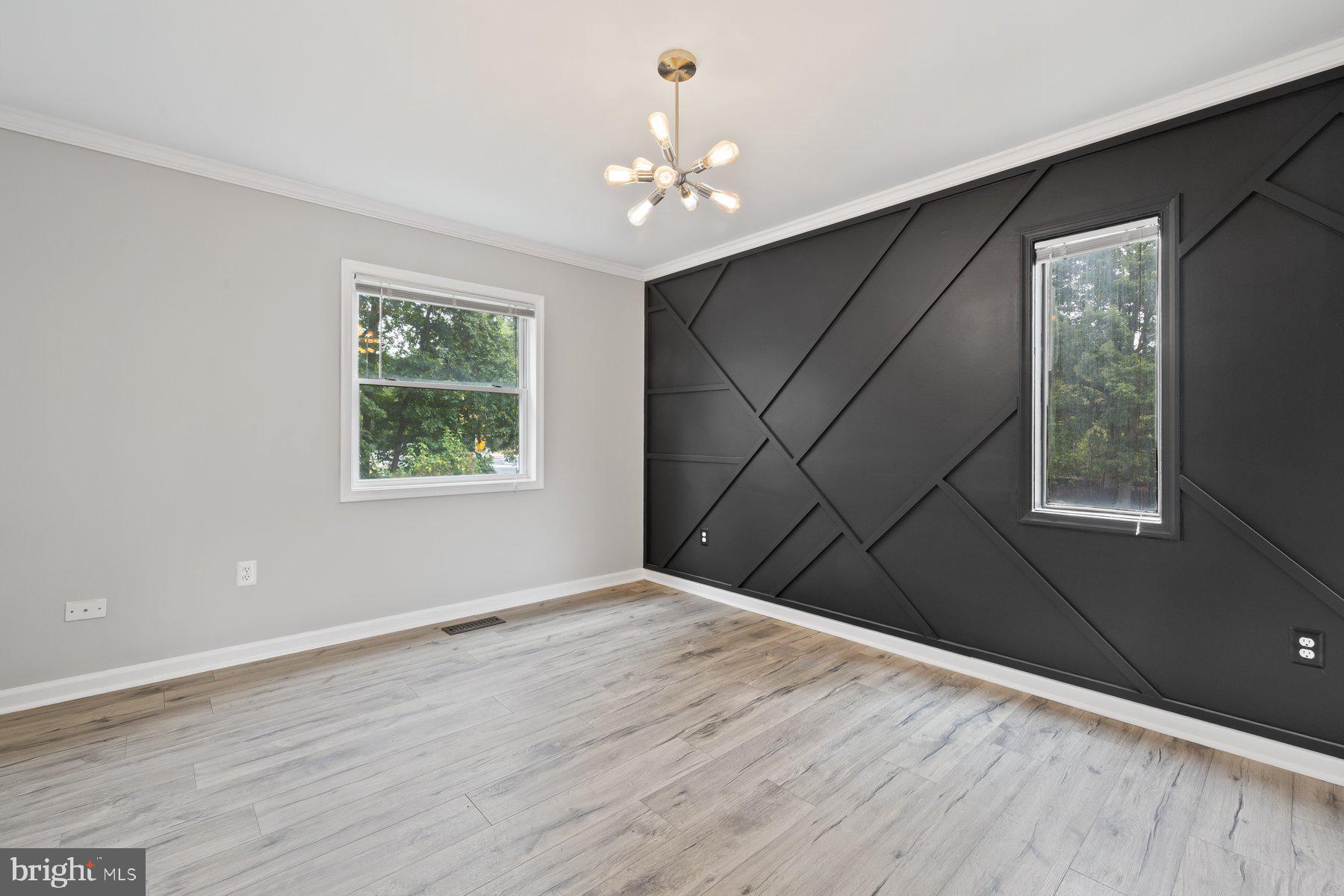 12537 Basque Place Woodbridge, VA 22192 - Photo 9 of 38 a view of an empty room with wooden floor and a window