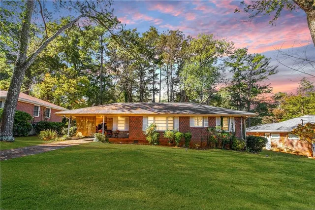 a front view of a house with a yard table and chairs