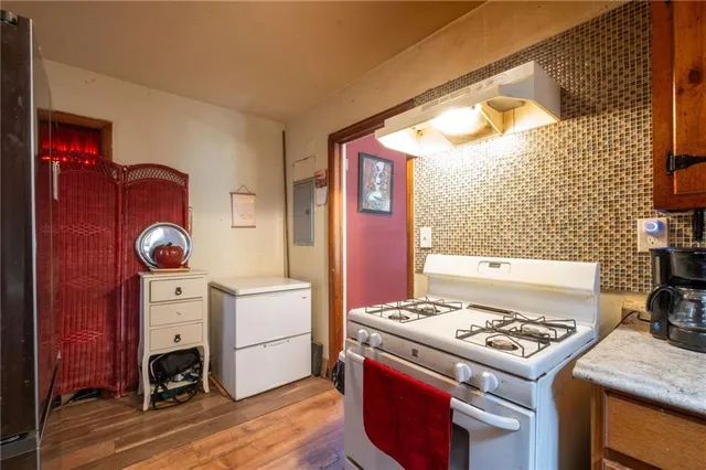 a kitchen with a stove and a refrigerator