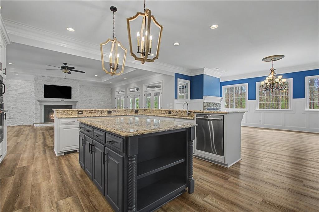 3045 Camp Branch Road Buford, GA 30519 - Photo 14 of 76 a kitchen with stainless steel appliances granite countertop a stove and a wooden floors