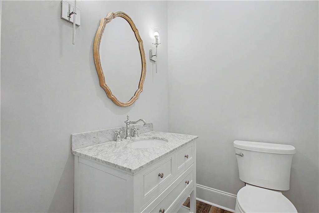 3045 Camp Branch Road Buford, GA 30519 - Photo 17 of 76 a bathroom with a toilet a sink and mirror