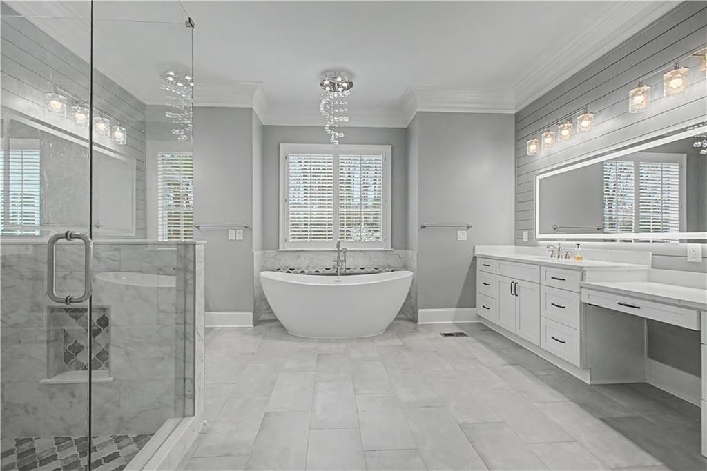 3045 Camp Branch Road Buford, GA 30519 - Photo 23 of 76 a spacious bathroom with a double vanity sink a mirror and a bathtub