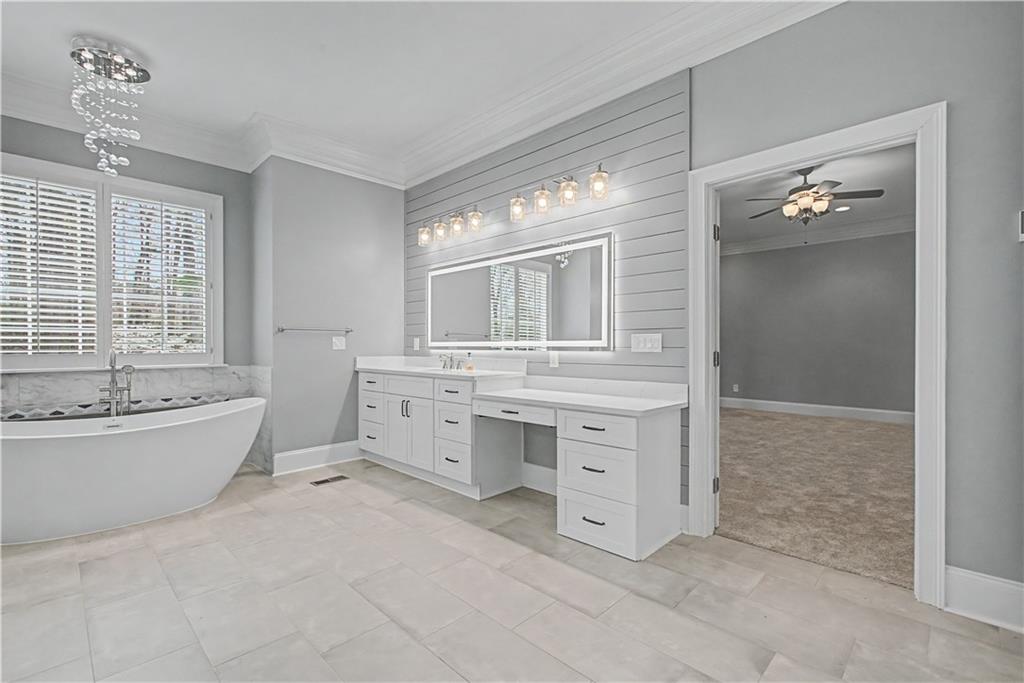 3045 Camp Branch Road Buford, GA 30519 - Photo 24 of 76 a bathroom with a granite countertop sink toilet tub and shower